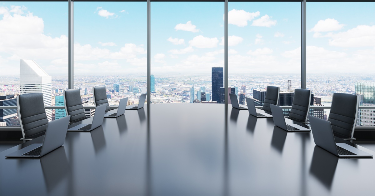 Empty executive board room overlooking city.