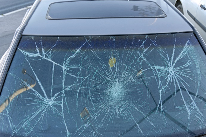 Car windshield with hail damage