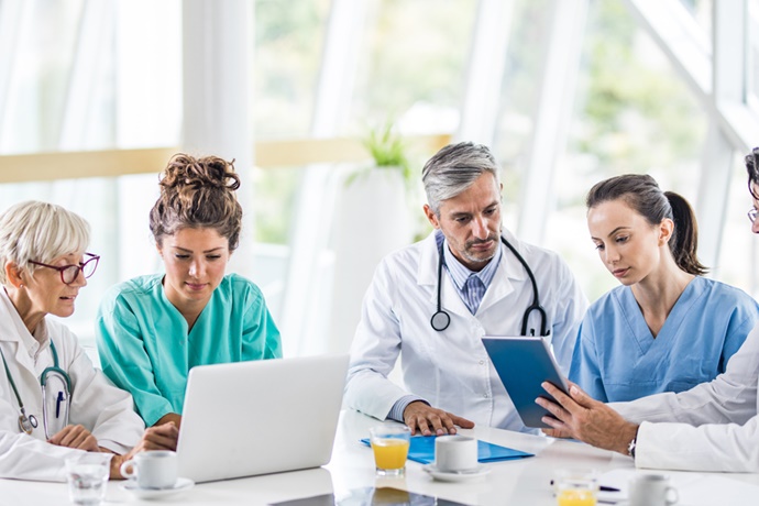 Doctors meeting around a table in conference room