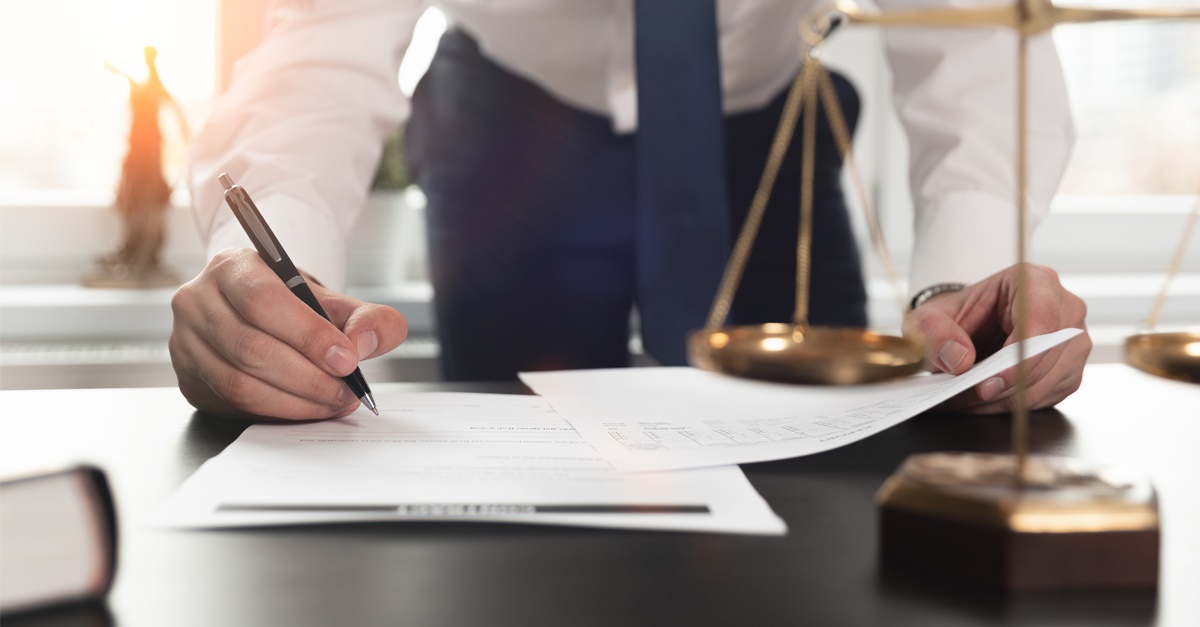 Attorney Reviews Insurance Policy Exclusions on His Desk