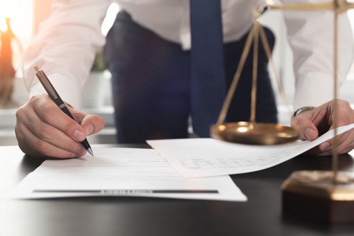 Attorney Reviews Insurance Policy Exclusions on His Desk