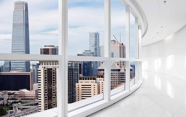 white-interior-hallway-overlooking-city