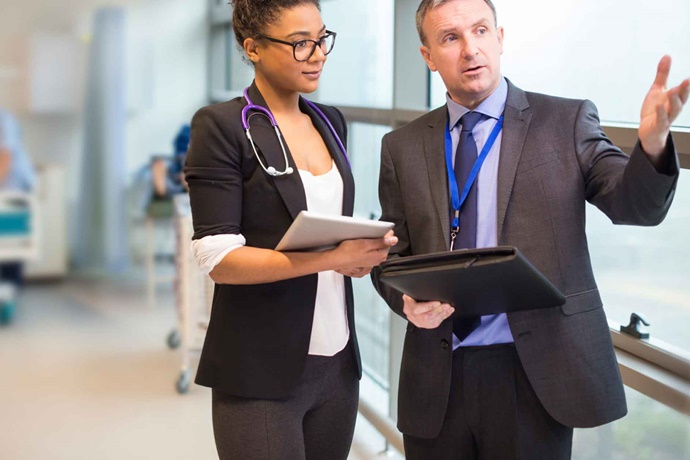 Two doctors talking in hospital hallway